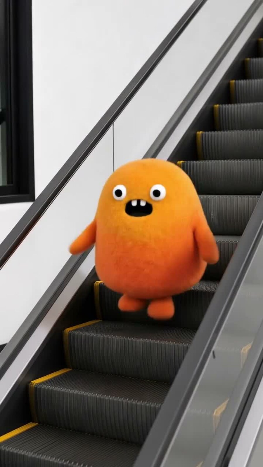 Nubo riding down an escalator alone